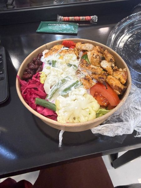 grabbed this on my lunch break and it lowkey slapped — grilled chicken, cauliflower, kidney beans, pickled cabbage, all of it. trying to eat a little cleaner this month. is this an actual win or am i lying to myself lol