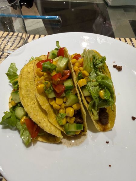 first time making tacos from scratch — beef, corn, cucumber, cherry tomato, little bit of everything. they FELL APART the second i picked them up but honestly tasted incredible. rate my attempt out of 10 lol